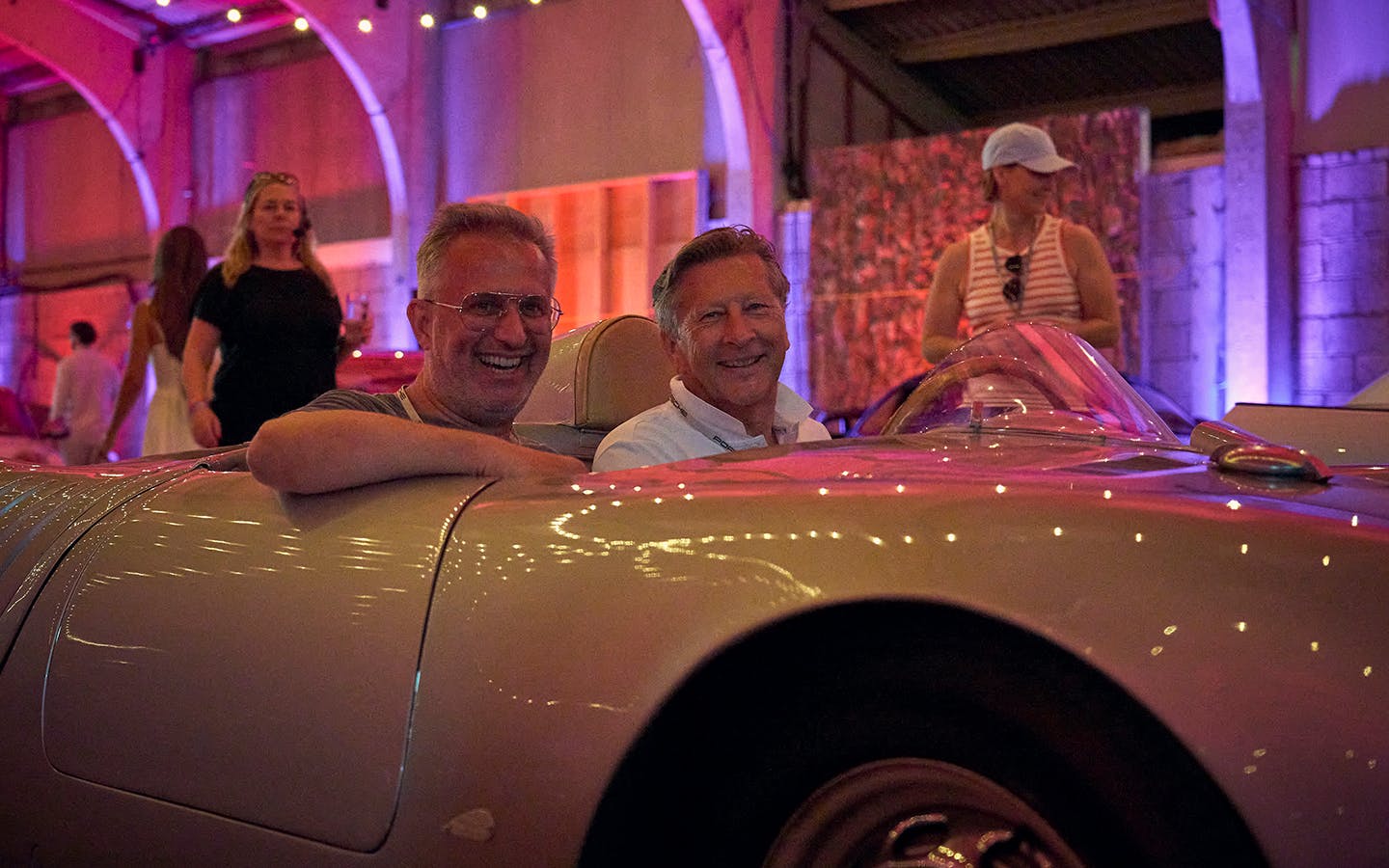Two men sat in Porsche 550 Spyder at Porsche Autokino, Goodwood Festival of Speed