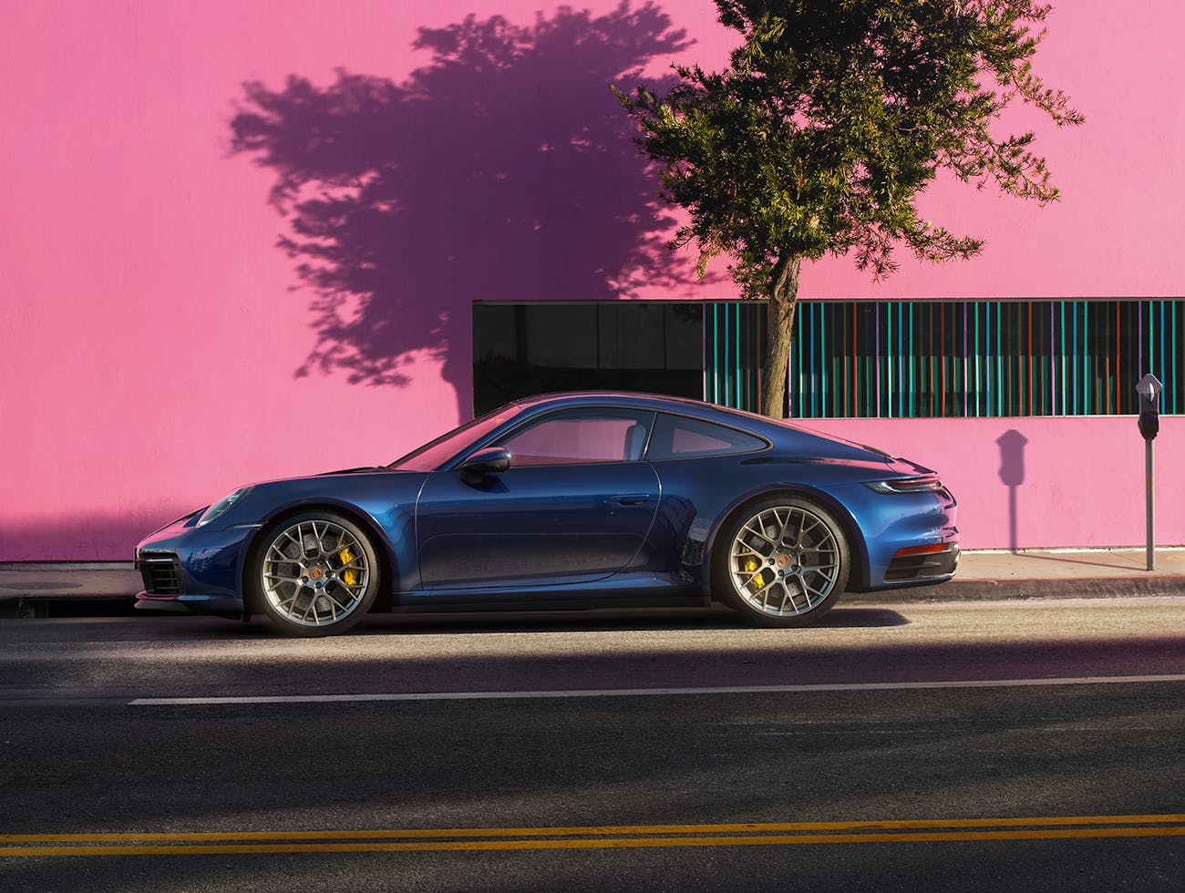 Porsche 911 Carrera 4S in Gentian Blue against pink wall