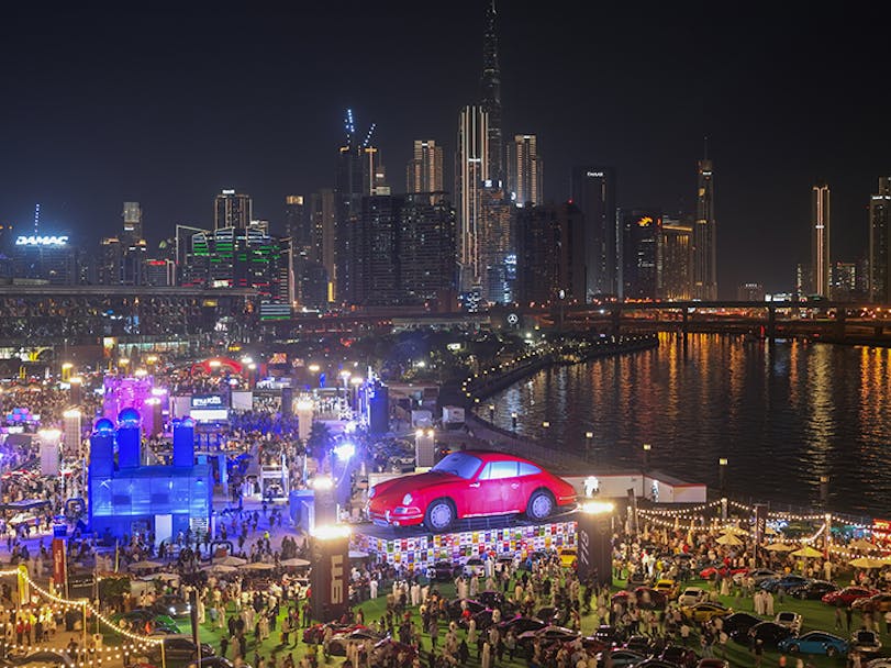 Life-sized red classic Porsche 911 display at the 2025 Icons of Porsche in Dubai 