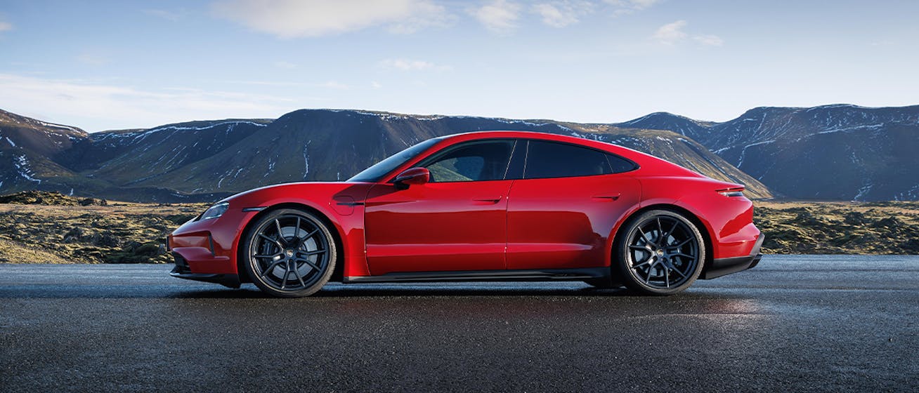 Porsche Taycan GTS in Carmine Red, with Icelandic scenery behind