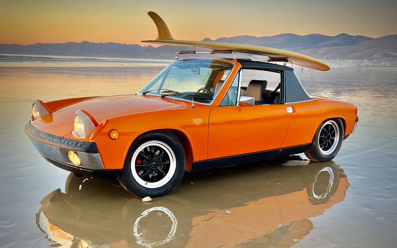 Porsche 914 in Signal Orange on Californian beach at sunset