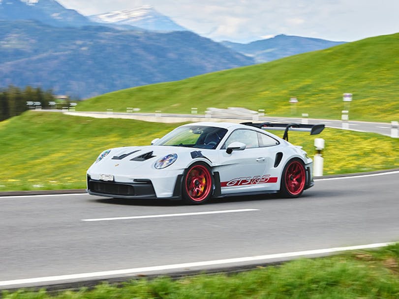 Porsche 911 GT3 RS (type 992) cornering on Alpine road