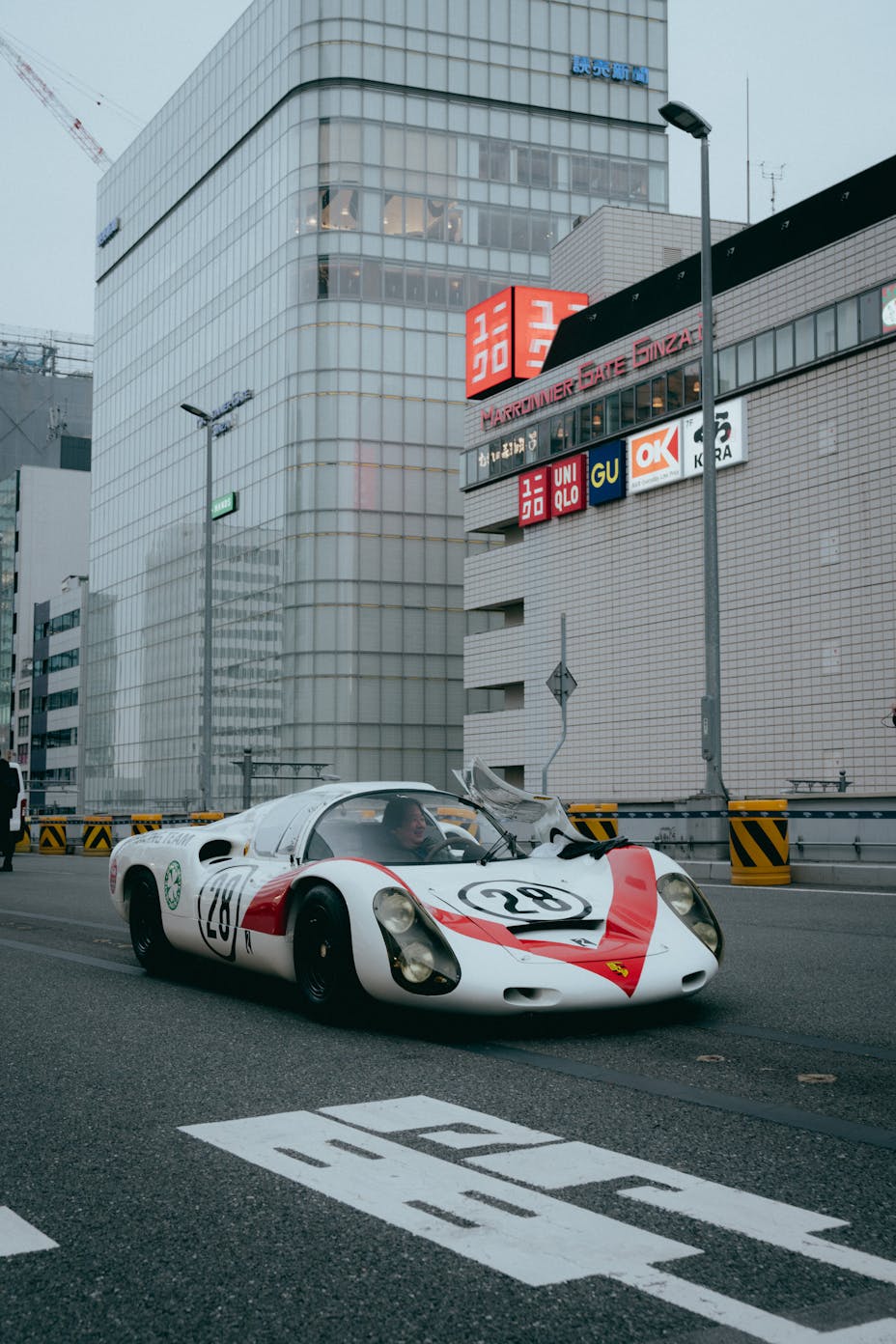 Historic Porsche 906 Carrera 6 racing car driving along the KK Line expressway in Tokyo