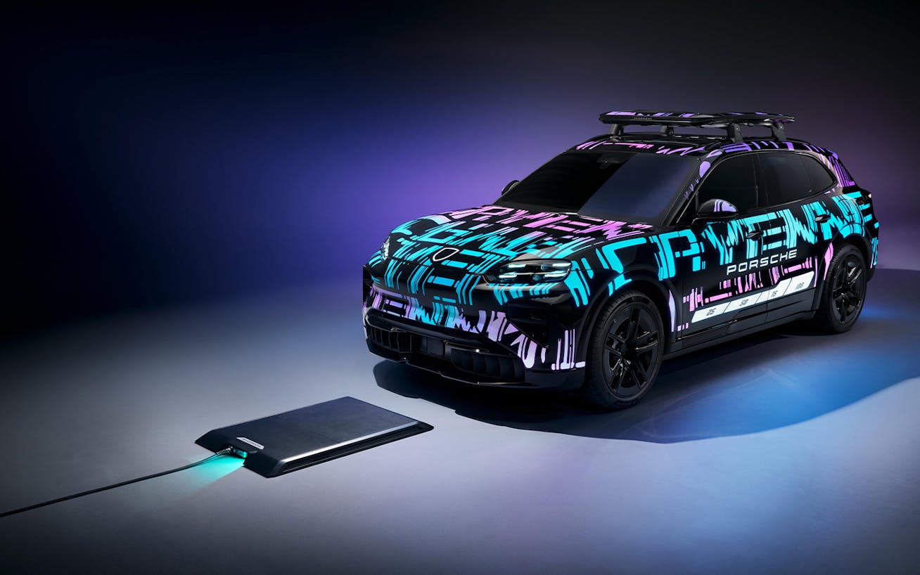 Cayenne Electric prototype about to drive over one-box base plate of Porsche Wireless Charging unit