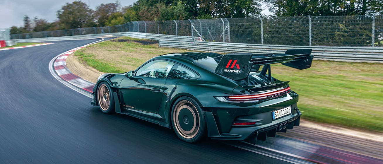 Porsche 911 GT3 RS with Manthey Kit cornering on racetrack