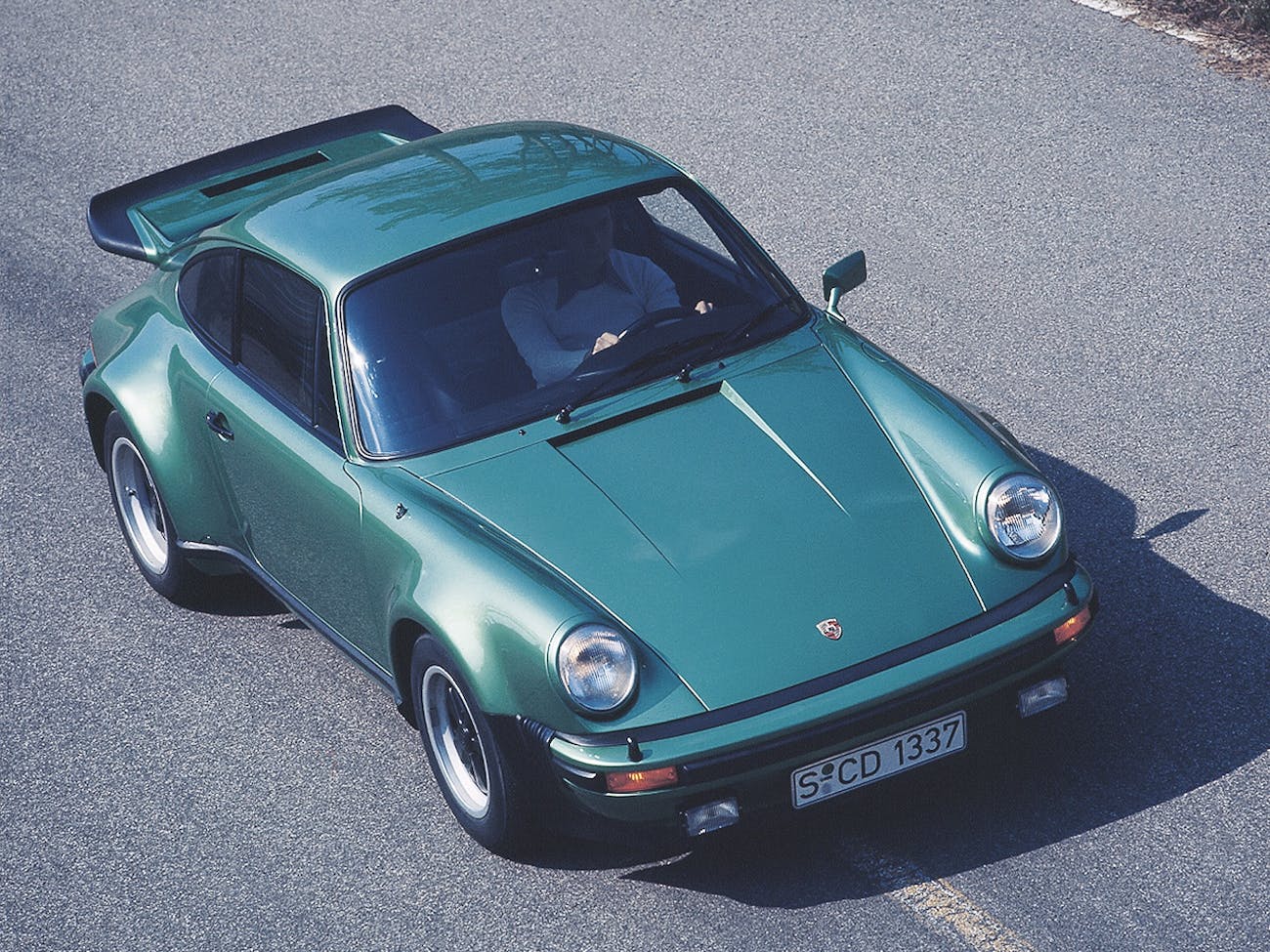 Green Porsche 911 Turbo, aka the type 930, on road
