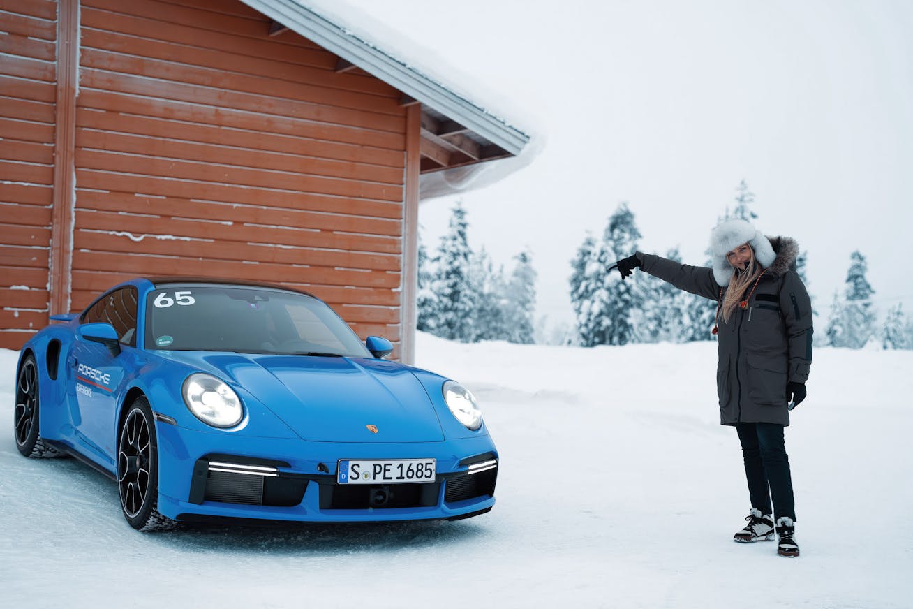 Woman with Porsche 911 Turbo S in very snowy conditions