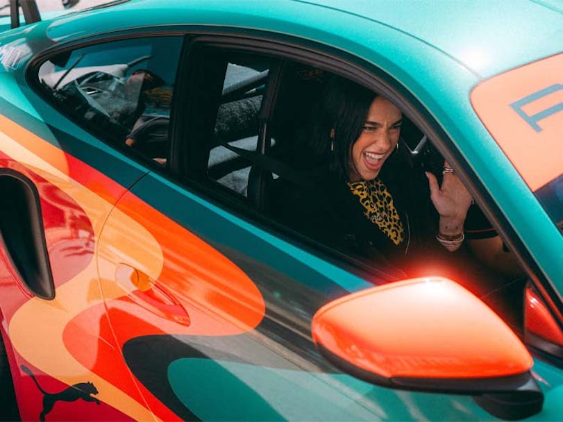 Dua Lipa behind the wheel of a Porsche 911 GT3 RS