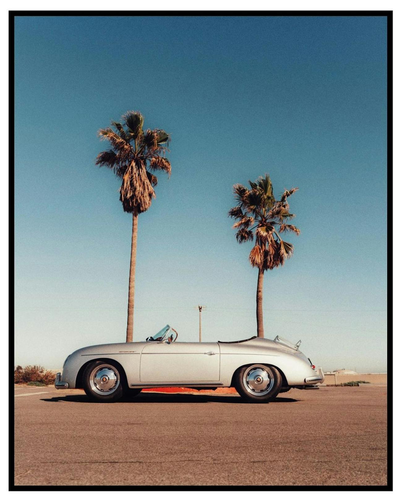 Classic Porsche in front of palm trees and under blue skies