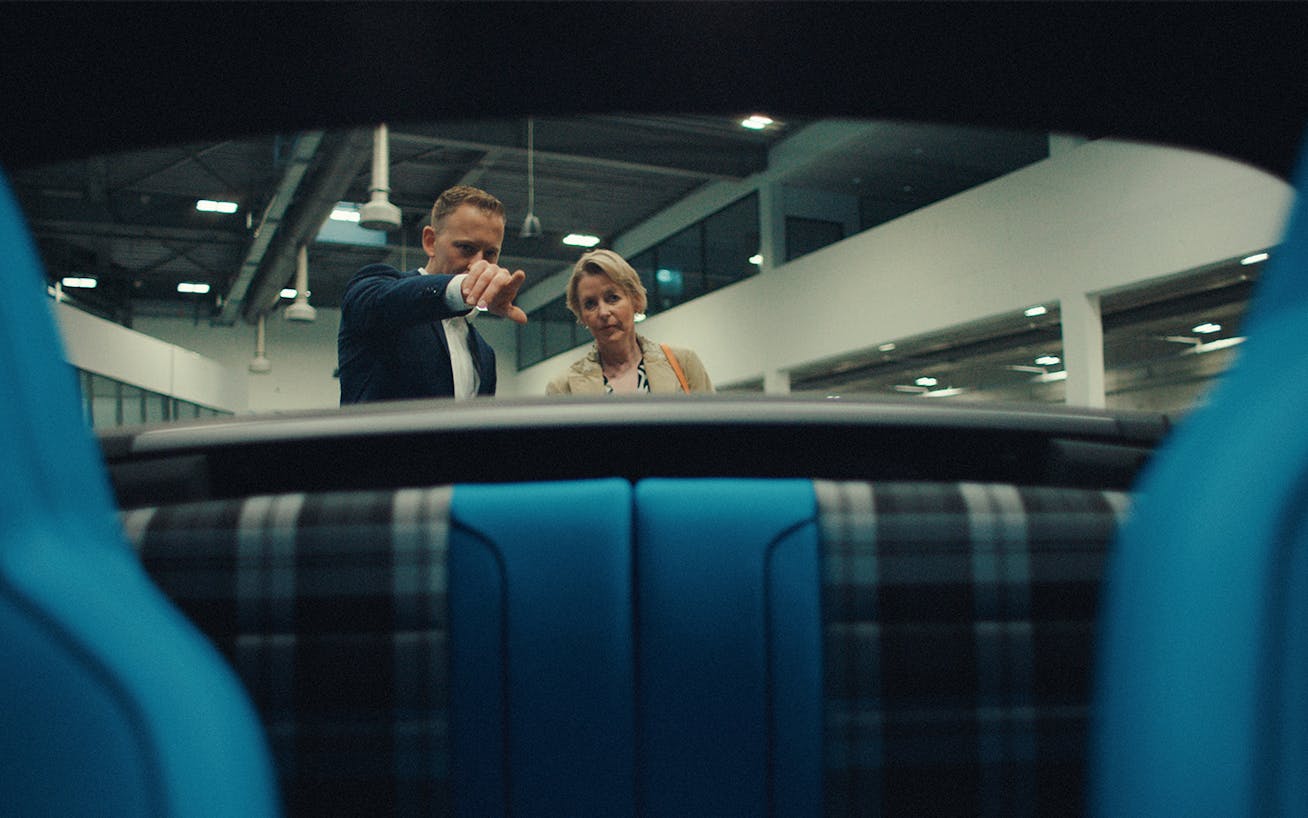 Man and woman discussing material samples next to photographic lightbox