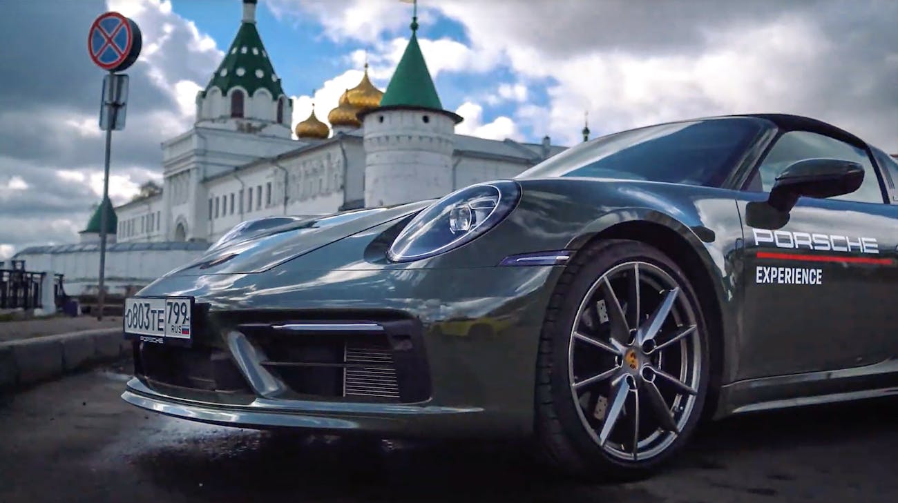 Porsche sports car in front of the white kremlin in Rostov
