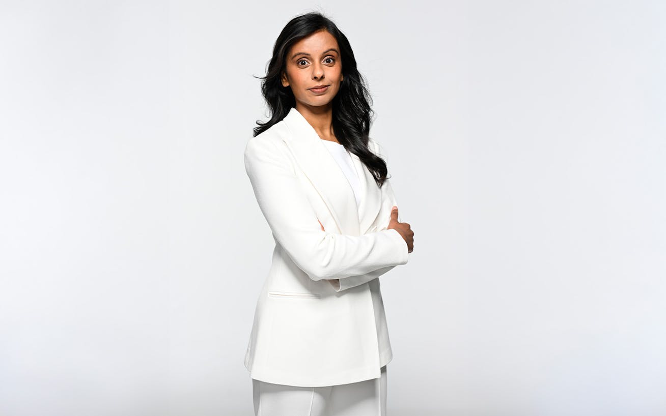 Woman in white suit with arms crossed