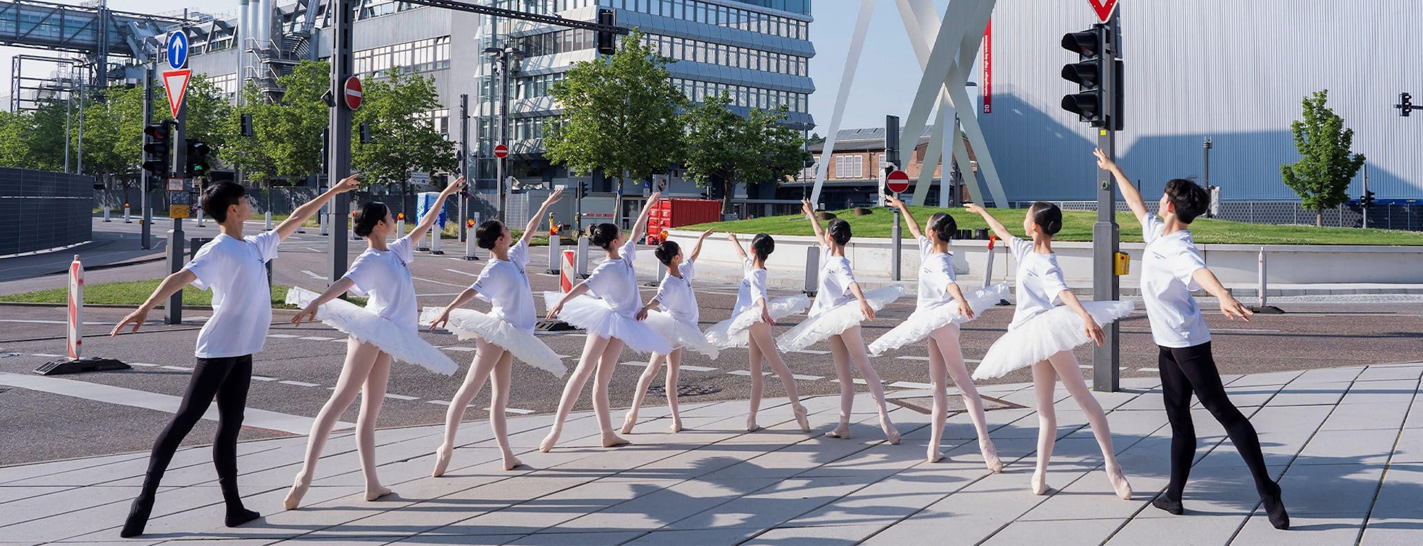 10 ballet dancers pose outside the Porsche Museum in Stuttgart