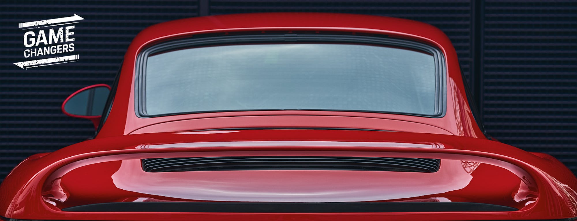 Rear of red Porsche 959 sportscar showing spoiler  